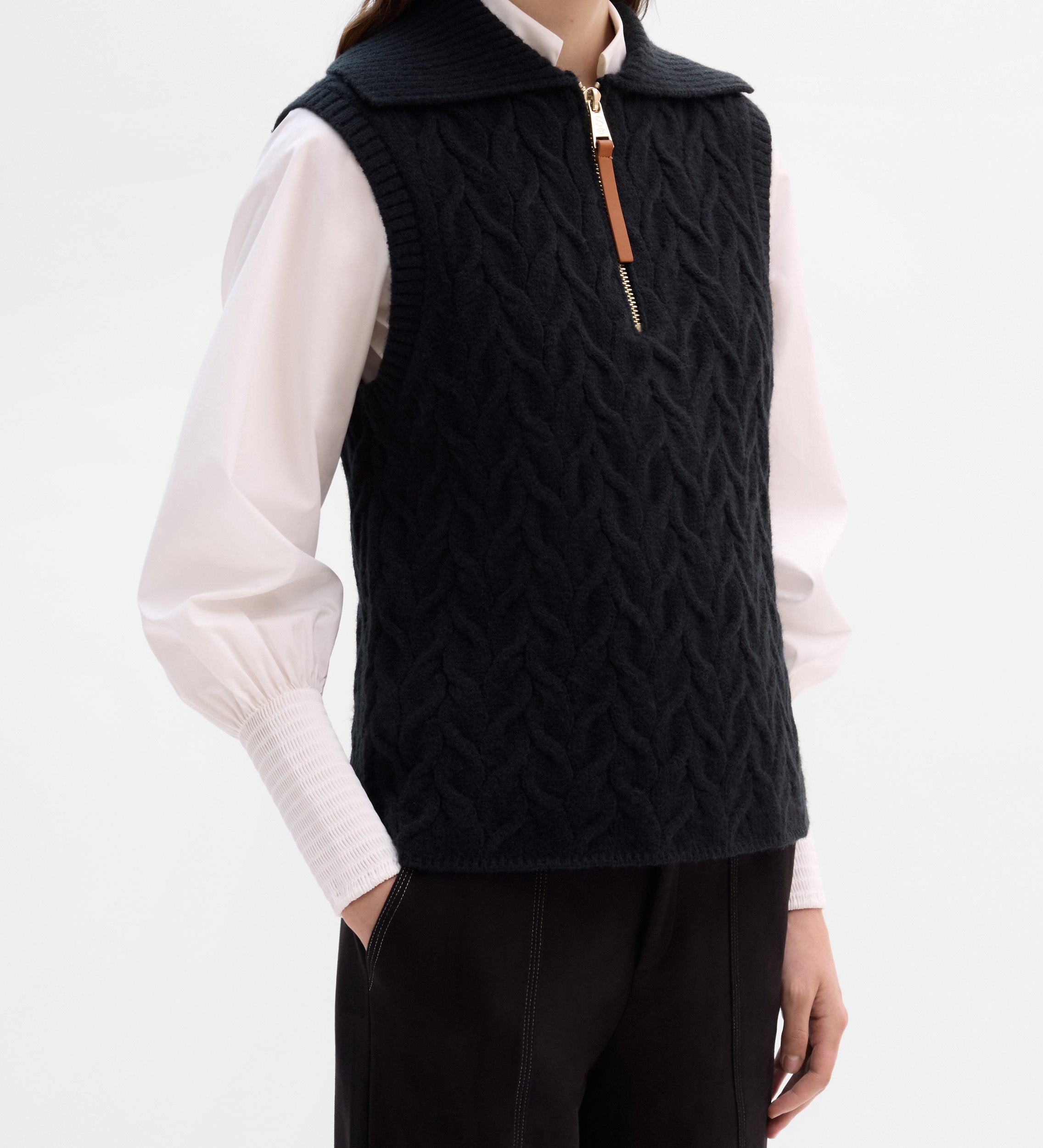 Knitted vest with braids