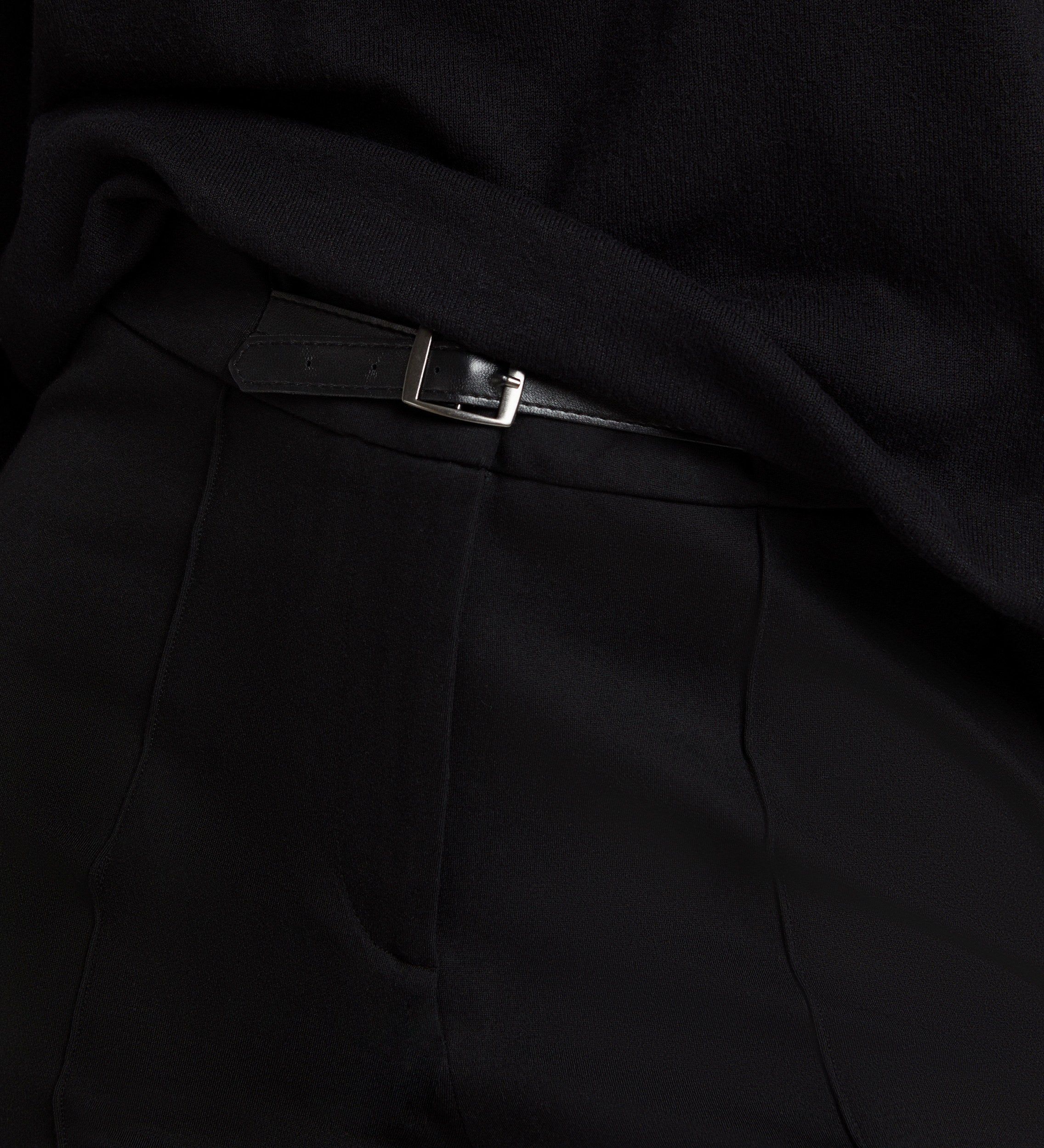 Elastic flared trousers with belt