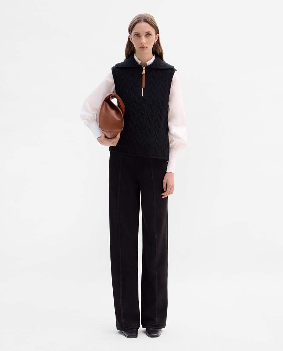 Knitted vest with braids