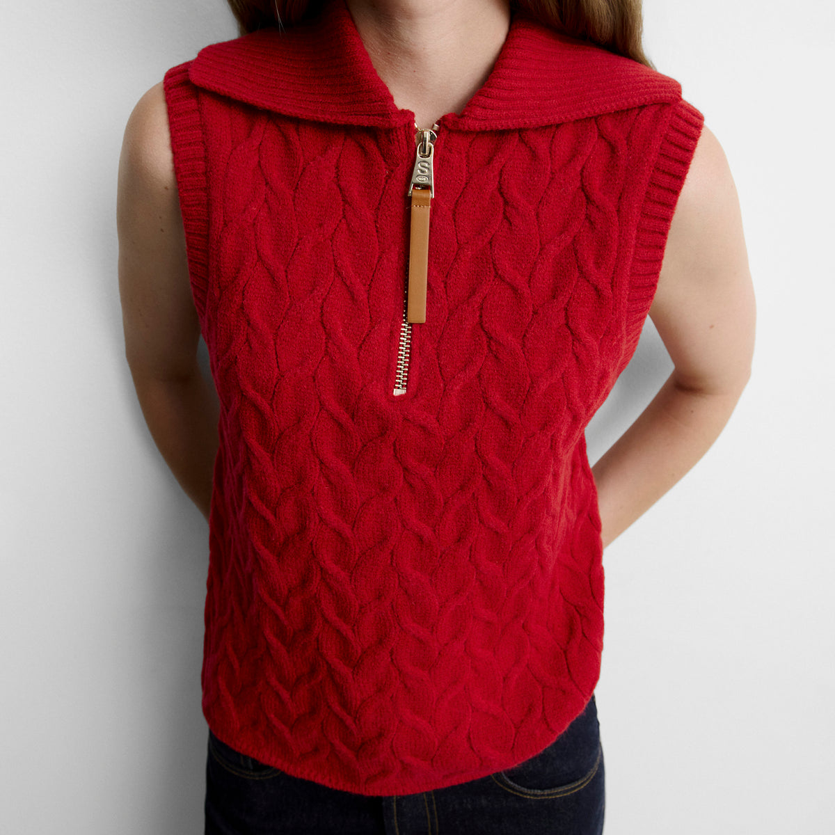 Knitted vest with braids